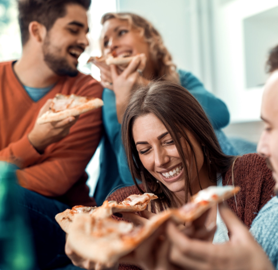 Young people eating pizza with Cheese Powder